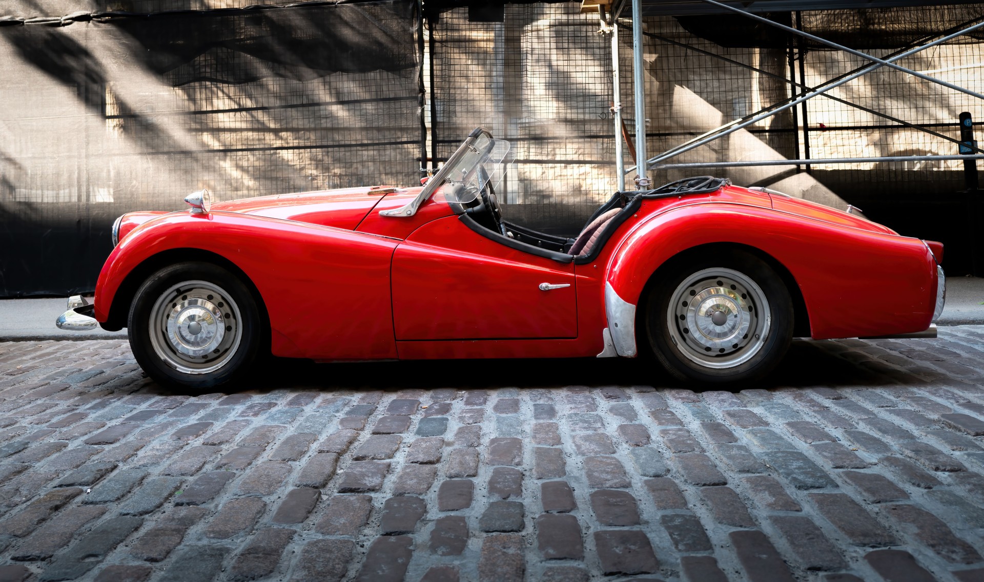 Classic Car on a Cobblestone Road